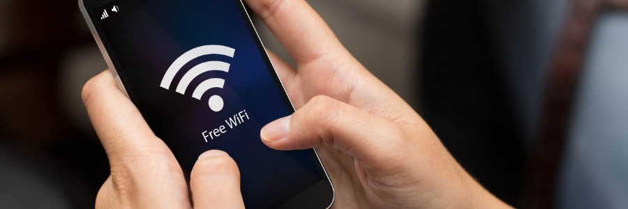 Hands holding smartphone displaying Free WiFi connection screen for office guest network setup