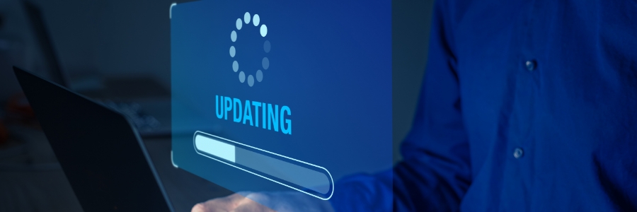 Person using laptop beside glowing blue virtual screen displaying firmware update progress bar and loading icon