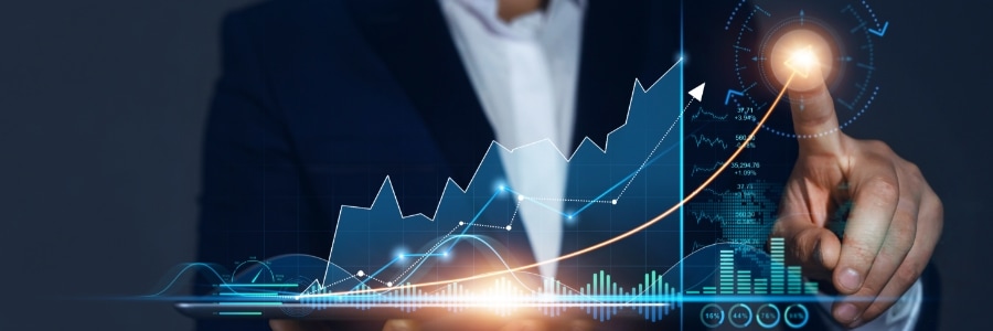 Businessperson touching a glowing digital growth chart with rising data analytics graphs on a holographic display