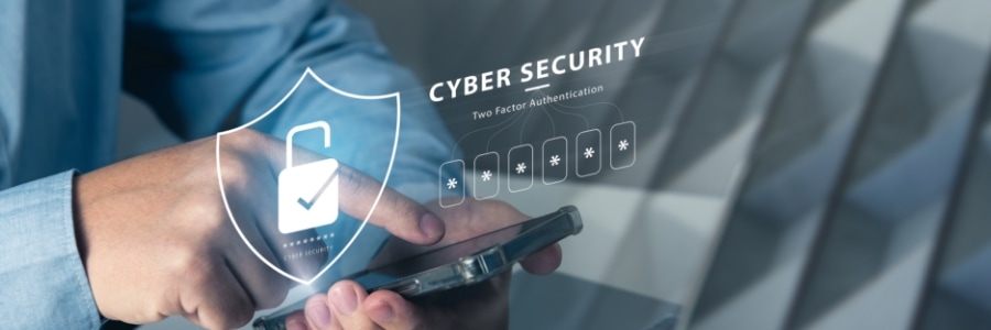 Hands holding smartphone with cybersecurity shield and two-factor authentication graphic overlay