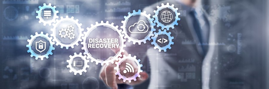 Businessman pointing at disaster recovery gear icons showing cloud backup, cybersecurity, and IT infrastructure concepts