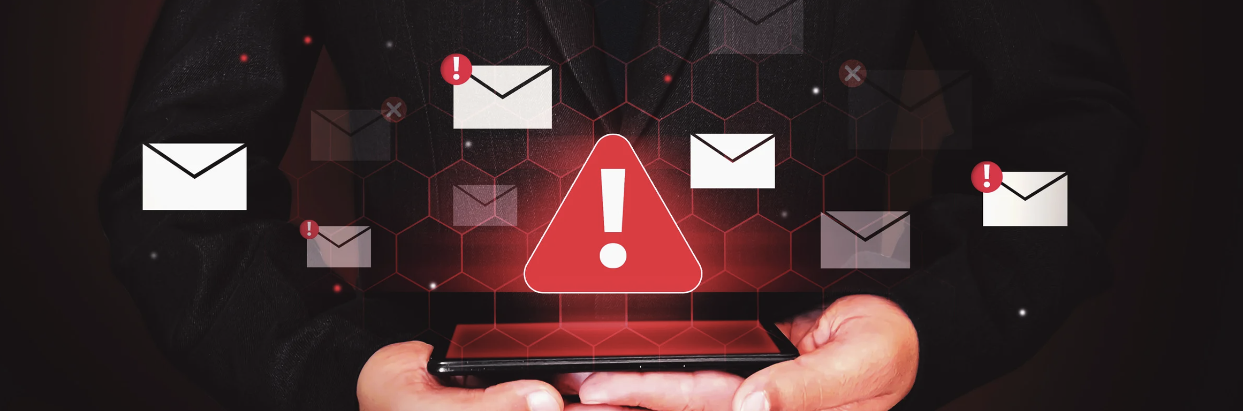 Person holding smartphone with floating email icons and red warning alert triangle, representing email security threats