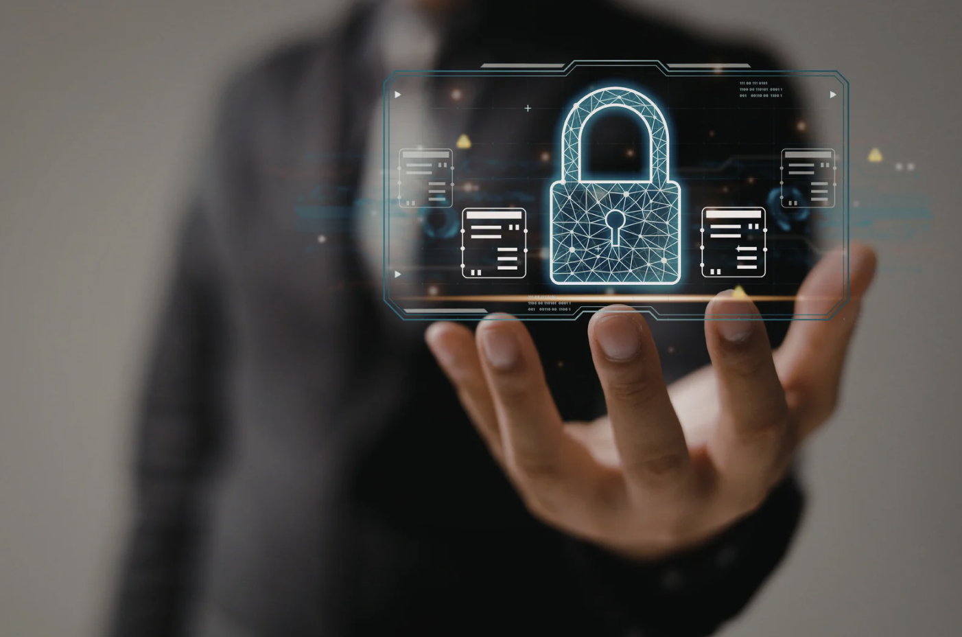Businessman holding holographic cybersecurity interface with glowing padlock and data protection icons