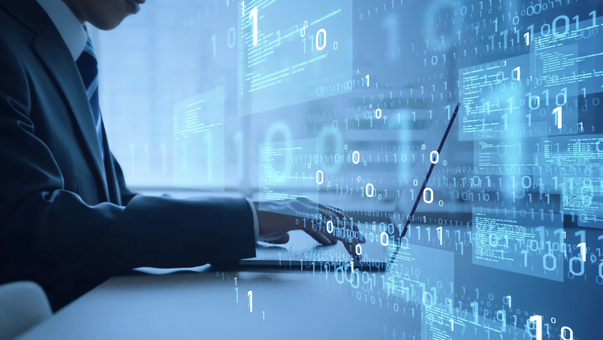 Business professional typing on laptop surrounded by floating binary code and digital data streams