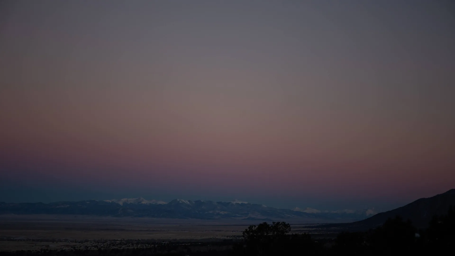 Night landscape under a star-filled sky above the mountains at Crestone