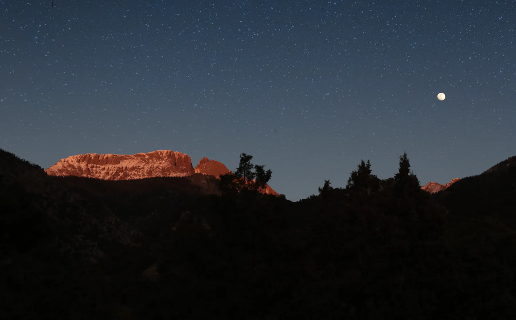 Star-filled night sky above the mountains at Crestone Mountain Zen Center