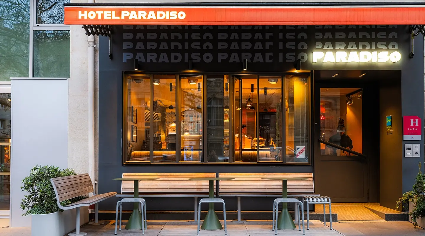 Façade blanche moderne à fenêtres alignées avec toit-terrasse végétalisé, entrée du cinéma mk2 Nation au rez-de-chaussée