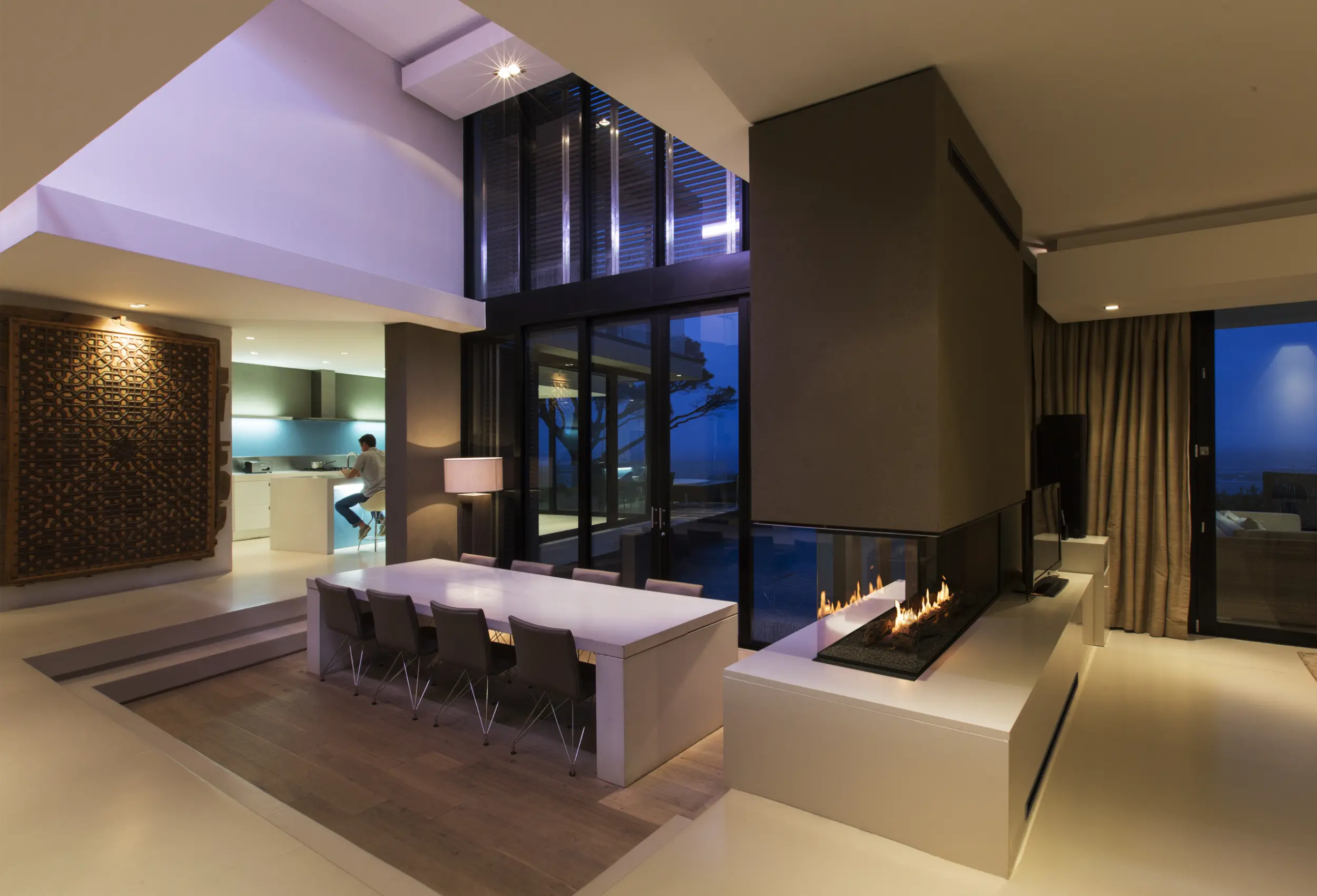 Three-sided glass bioethanol room-divider fireplace with a linear flame