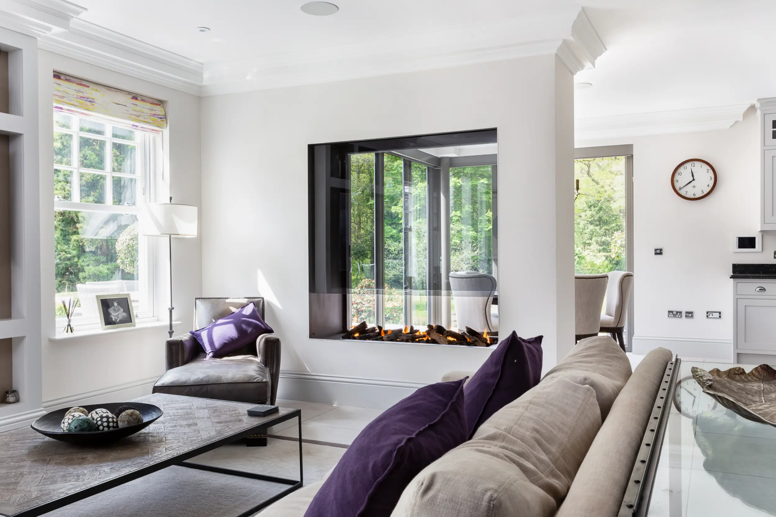 Double-sided linear gas fireplace with continuous ribbon flame in lounge space