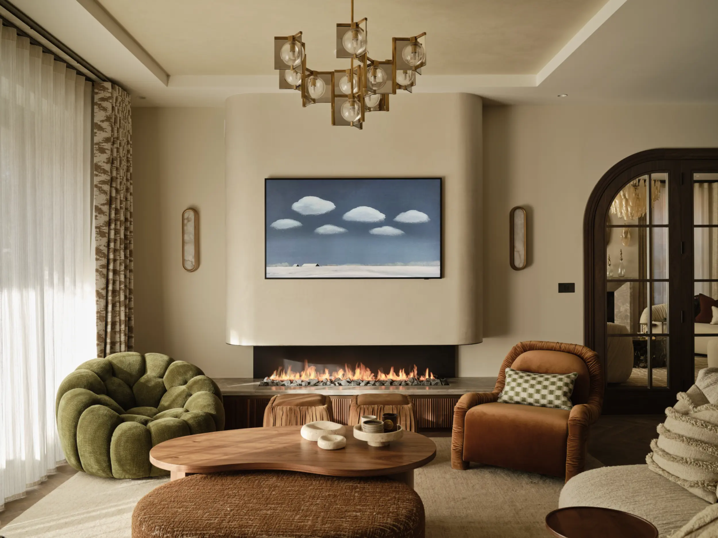Linear gas fireplace close up with fluted oak base, stone surround, lava rock fuel bed and smooth curved plastered flue