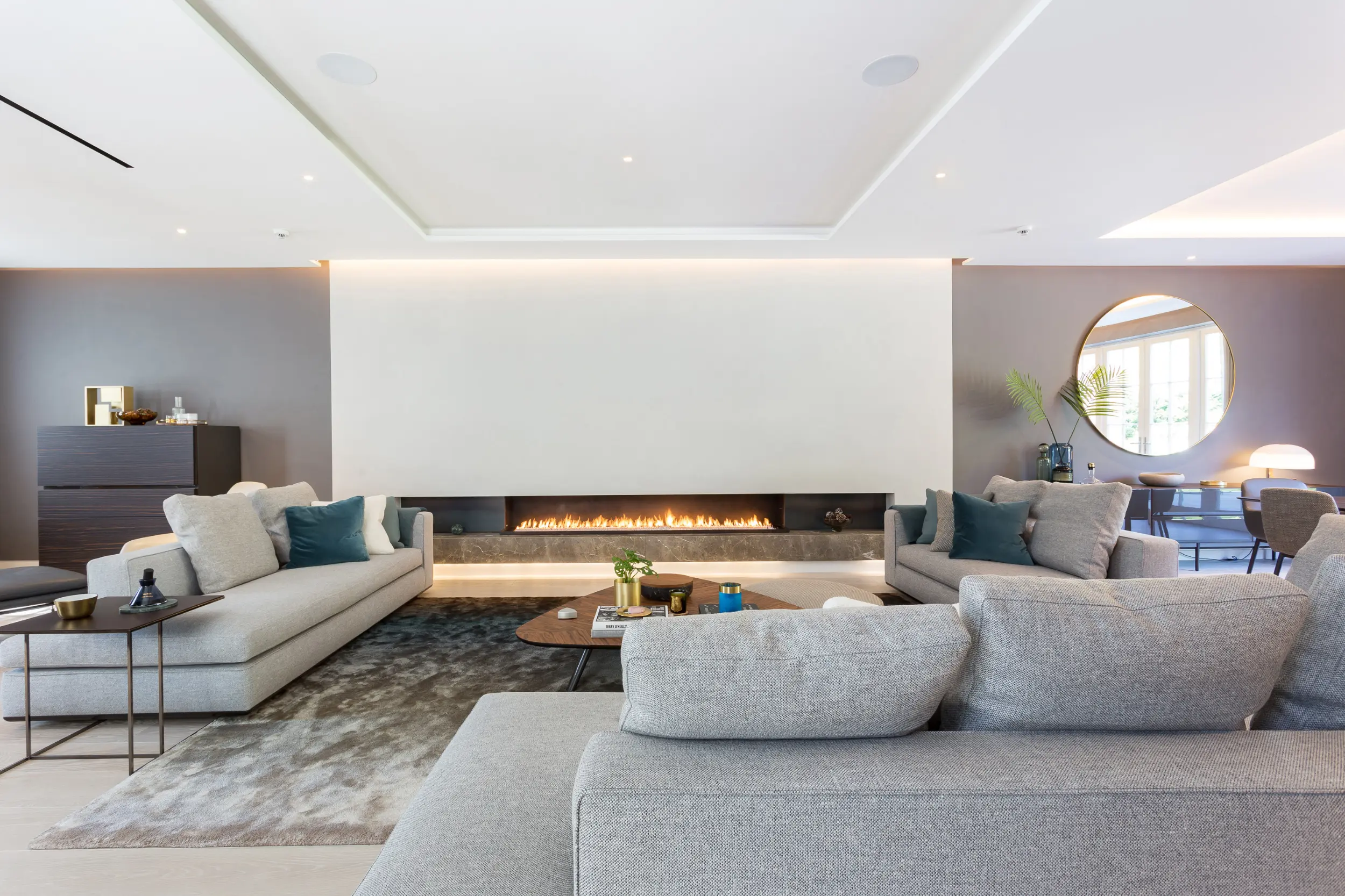 Close up of Bespoke 2.4-metre open-front linear gas fireplace with hot-rolled steel side panels in expansive living space