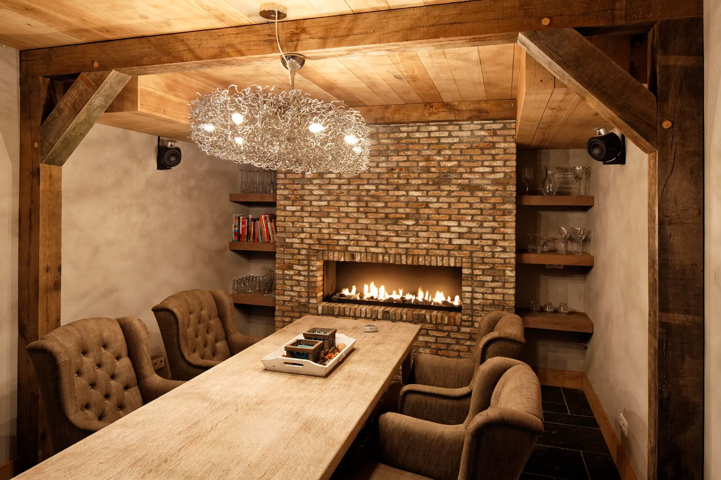 Contemporary 1.3-metre linear gas fireplace with matt black interior and limestone fire bed in a brick-clad barn chimney breast