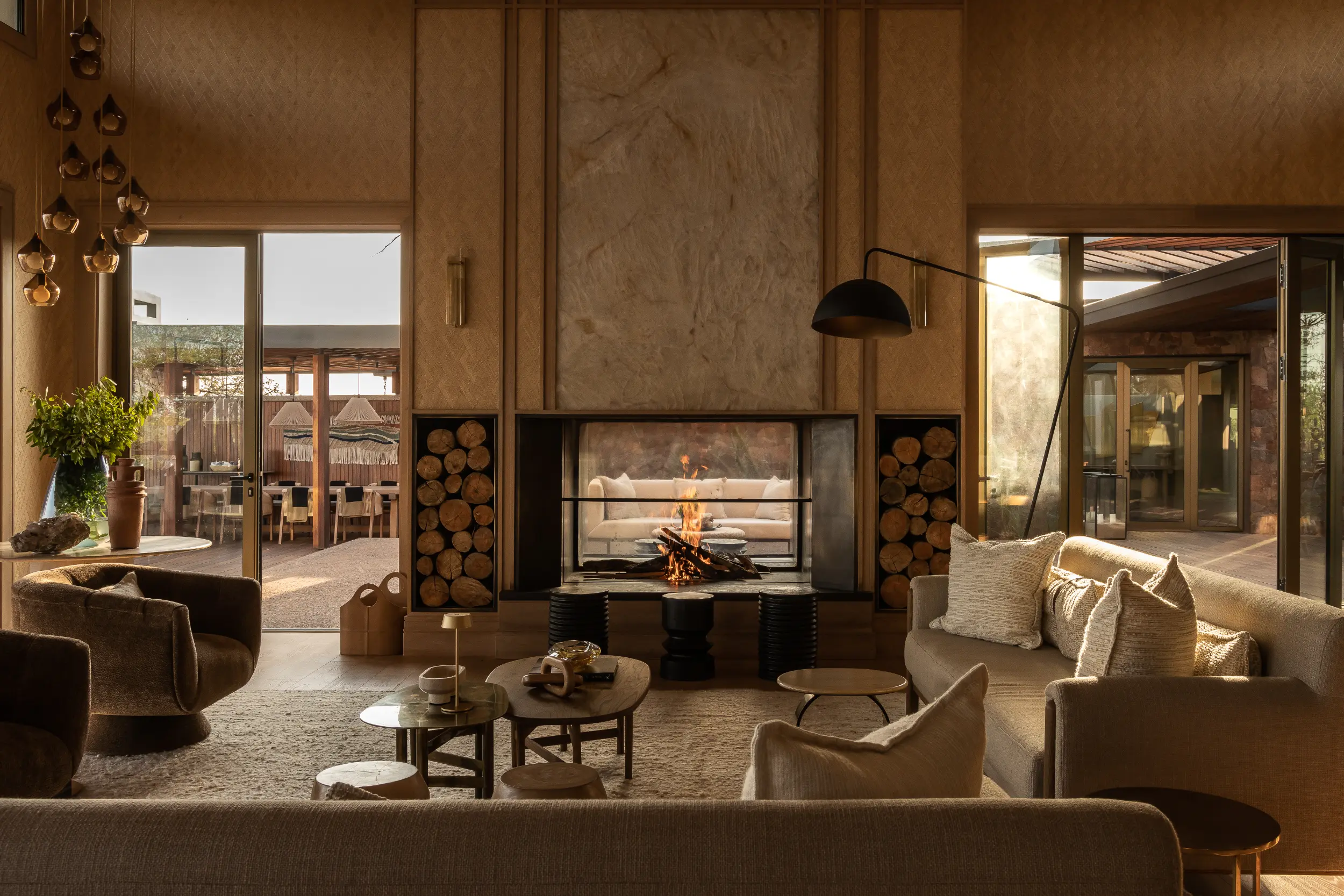 Glass-fronted indoor-outdoor fireplace designed for a Singita lodge in the Serengeti, integrating with the lodge's African design language