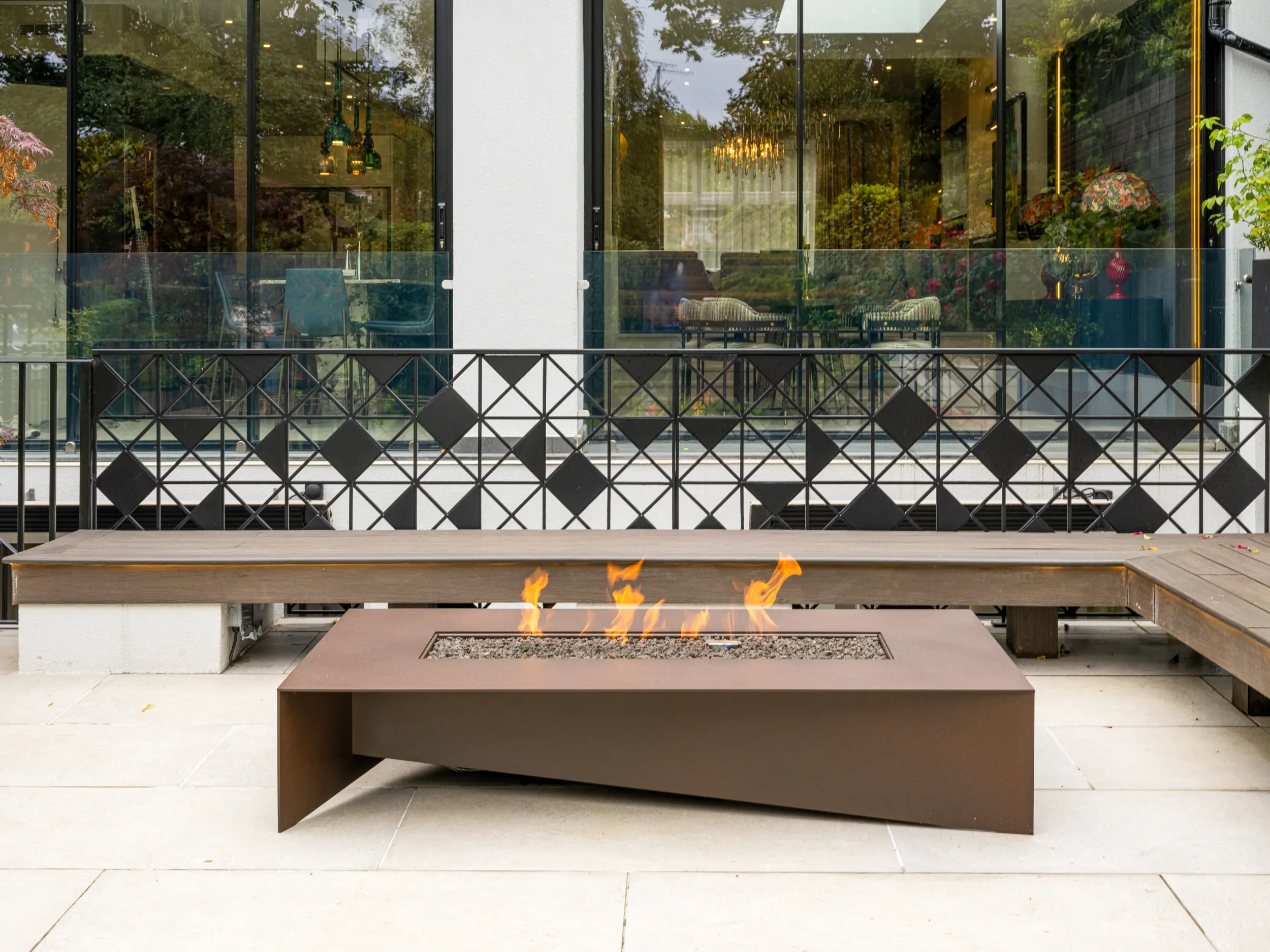 Asymmetrical outdoor gas fire table with bronze finish designed for a London residential terrace by Modus Fireplaces