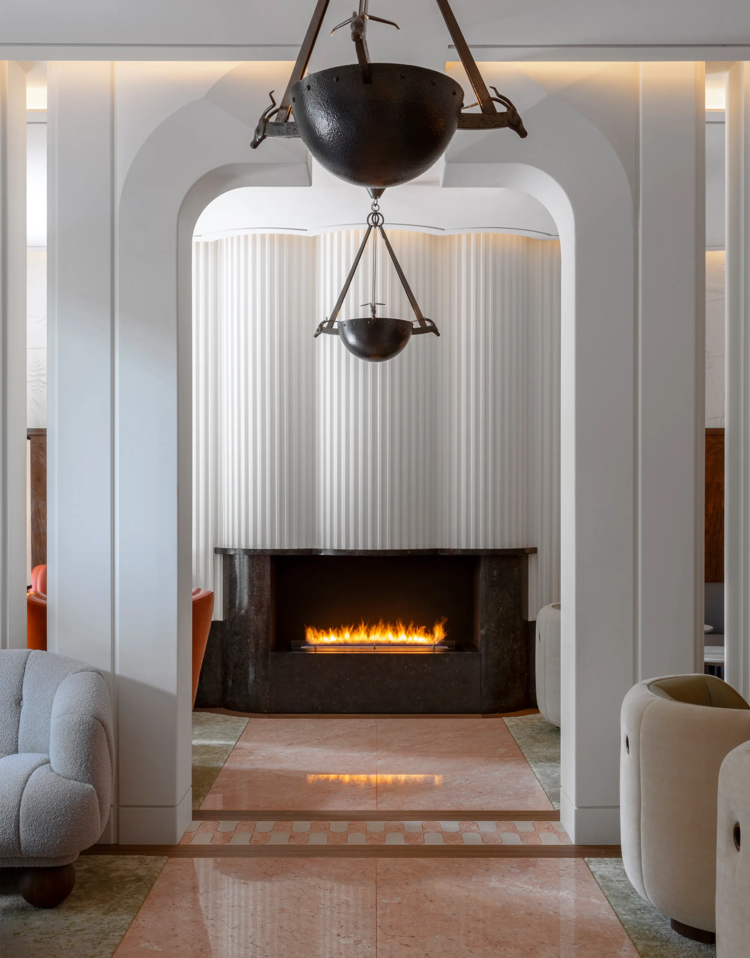 Bespoke gas fireplace beneath a fluted plaster flue in the Cigar Lounge at The Berkeley Hotel, London, by Modus Fireplaces