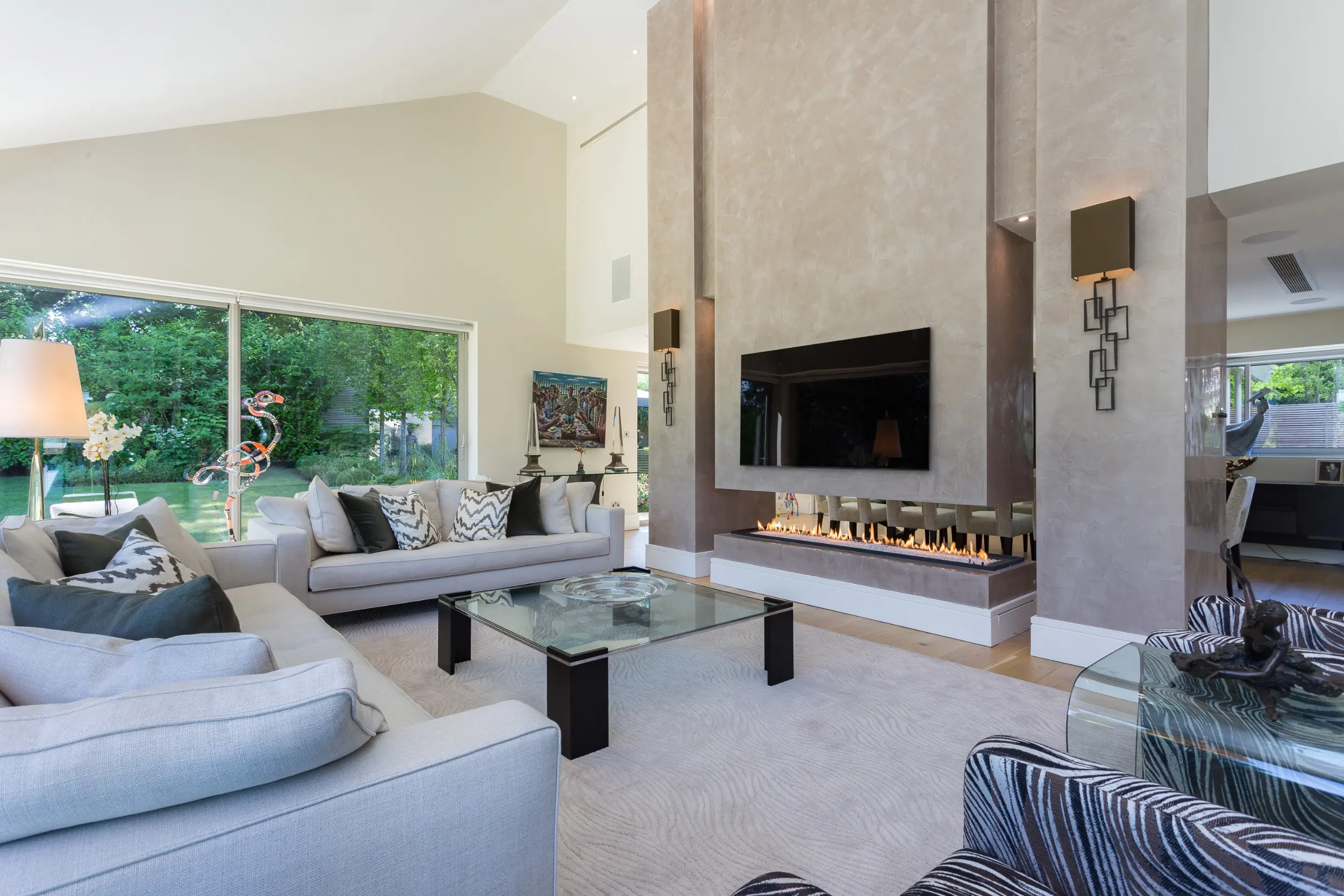 Suspended double-height fireplace and media wall with 2 metre ribbon flame polished plaster canopy