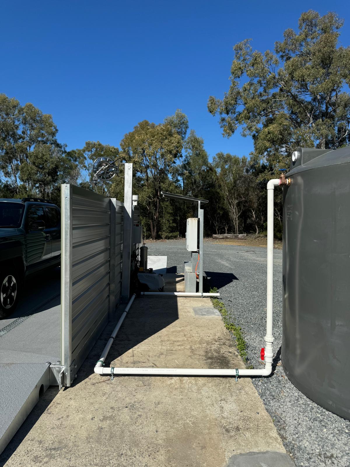 Forklift inside modular washbay with side screens and grated channels