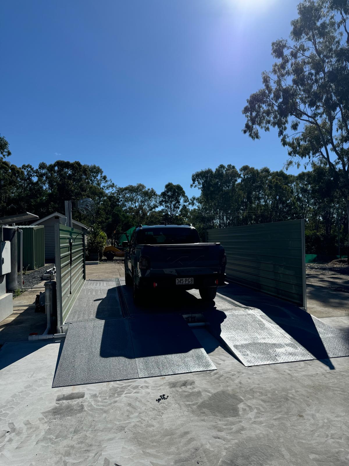 Completed modular washbay showing ramps, side screens and grated collection channels