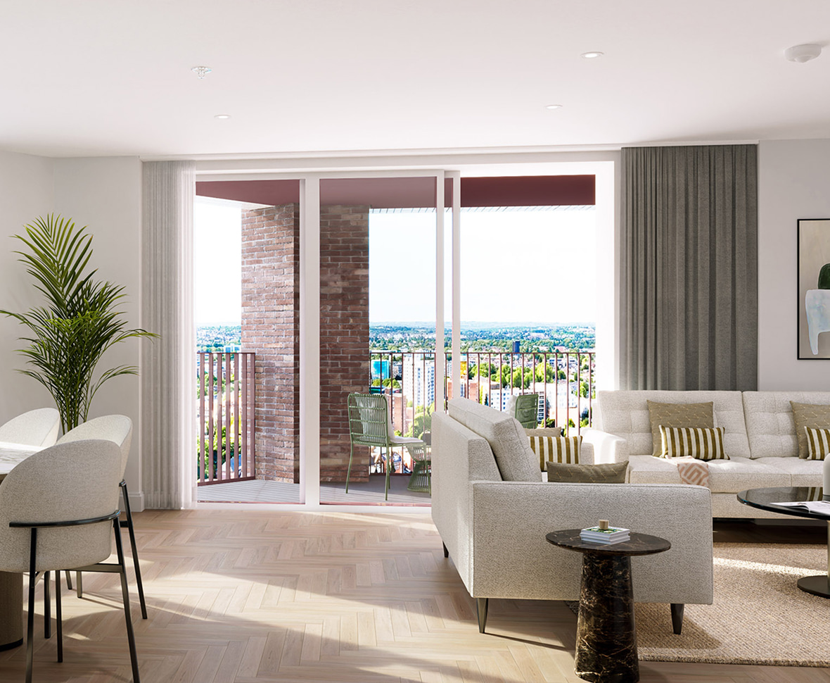 Bright living room with beige couches, a round table, plant, and balcony with city view.