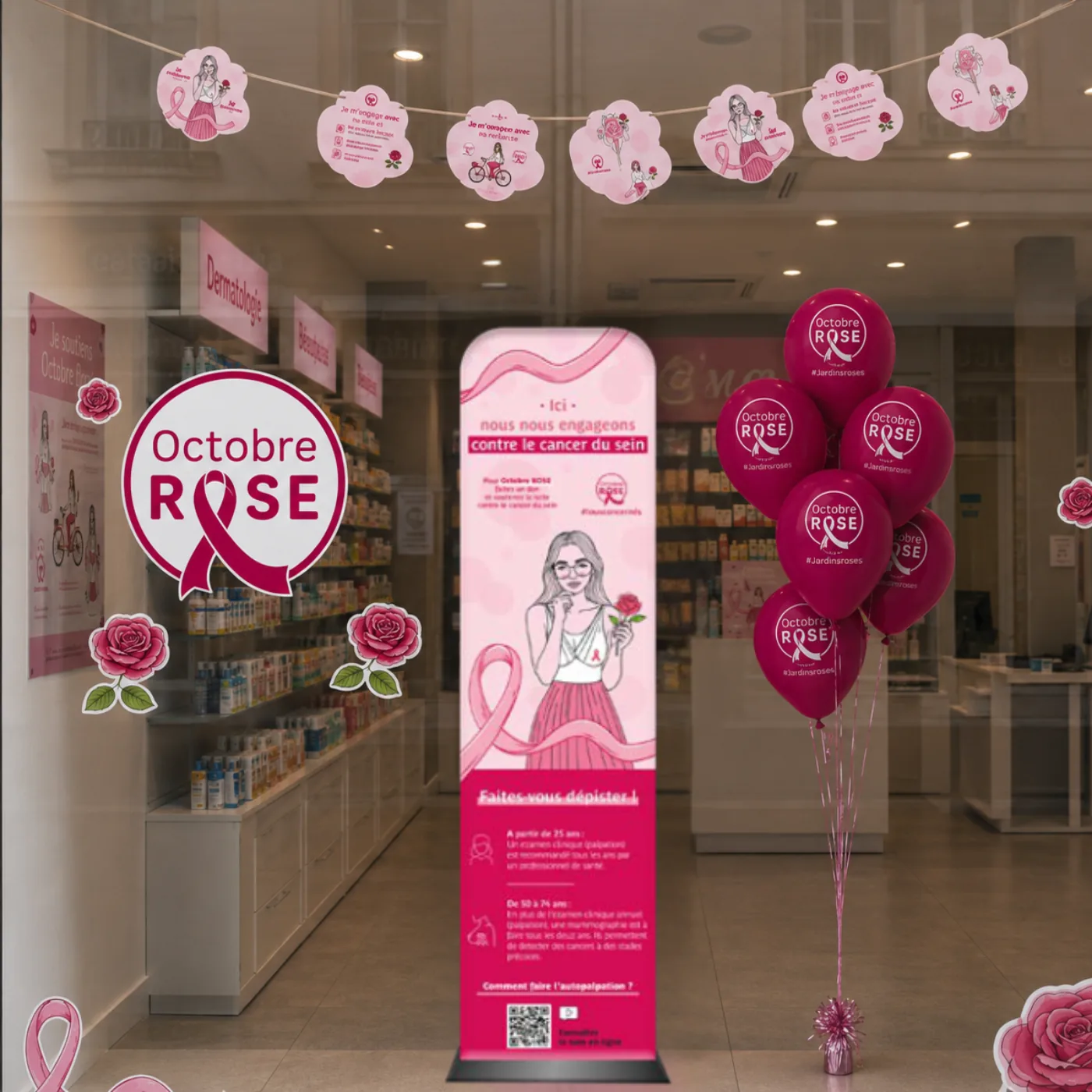Vitrine décorée pour Octobre Rose avec affiche, ballons roses et rubans pour sensibiliser au cancer du sein.