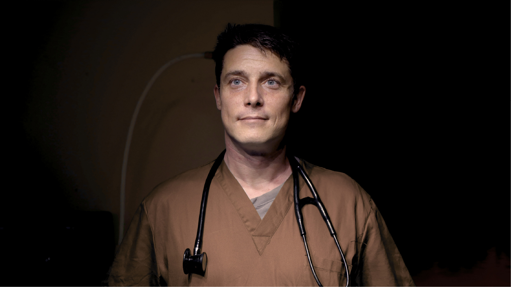 Doctor staring upward inspired before his shift.