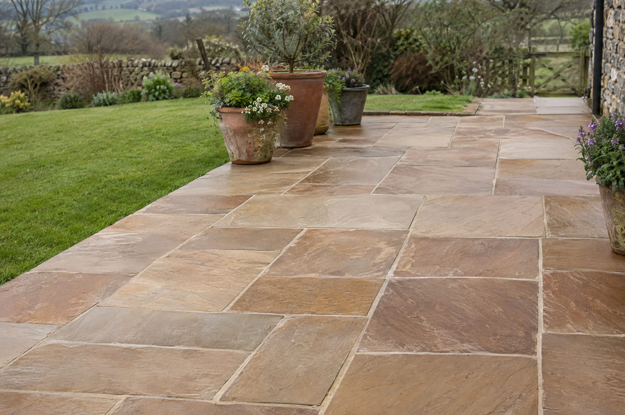 Clean stone paving with the joints clear and no run off across the border