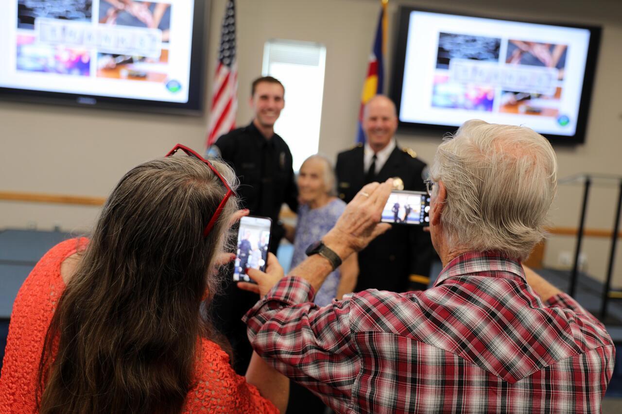 Family takes photos during Cody Hartkopp's promotion to sergeant.