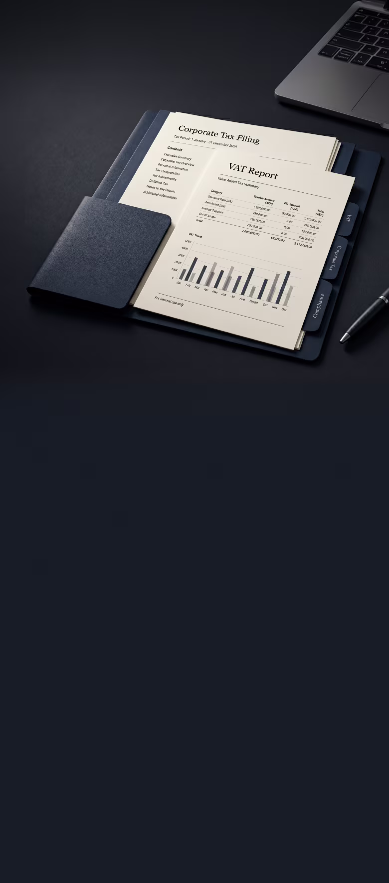 Open folder with Corporate Tax Filing and VAT Report documents beside a laptop and pen on a dark surface.