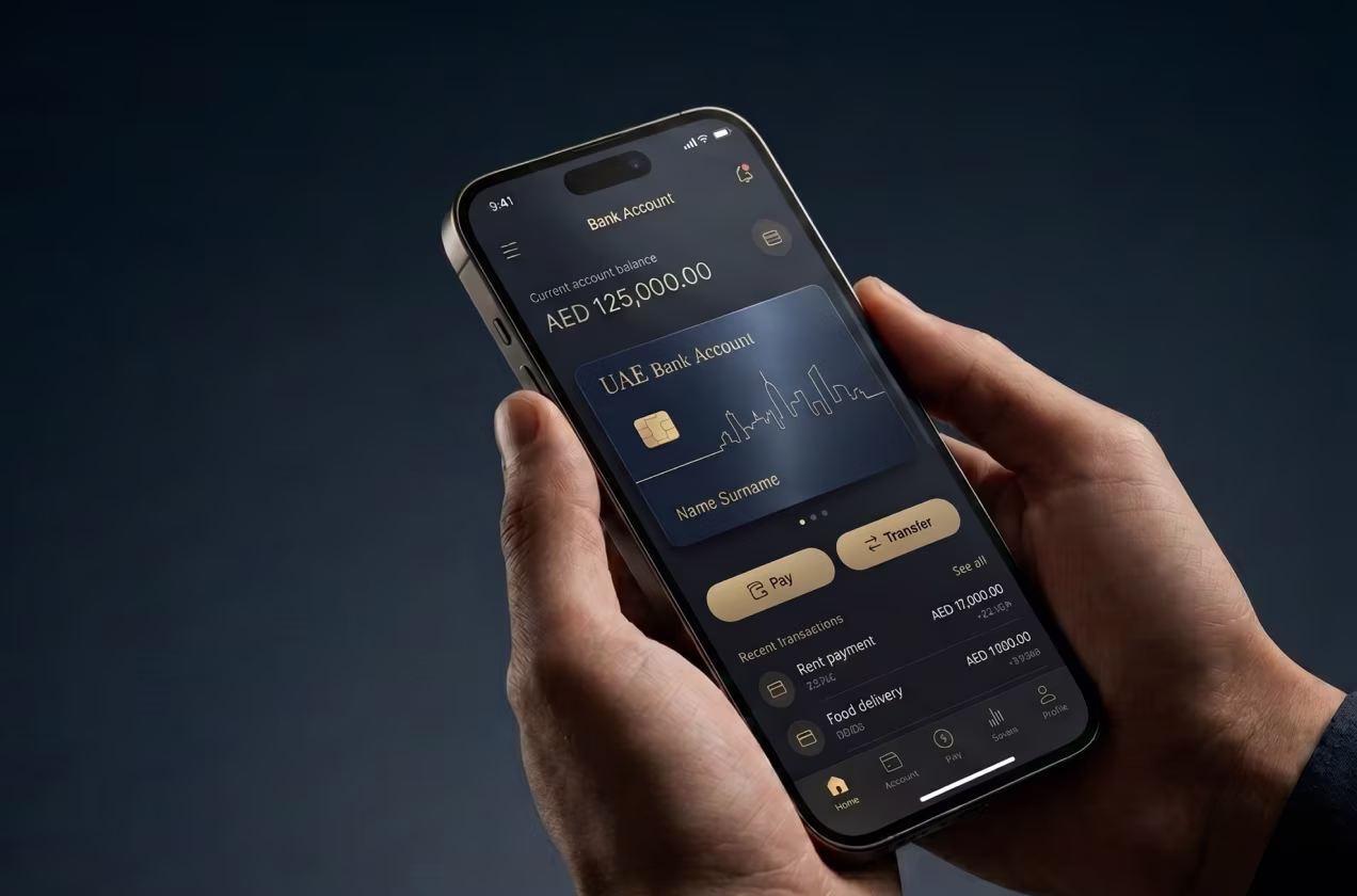 Person holding phone showing UAE bank app with AED 125,000 balance and recent transactions.