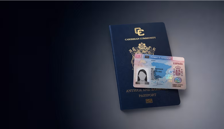 Antigua and Barbuda Caribbean Community passport with a Spanish residence permit card on top.