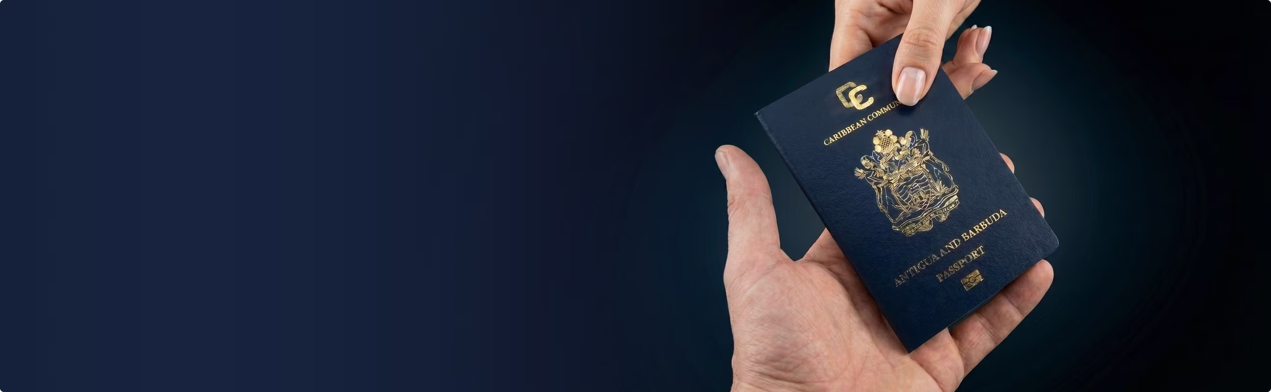 Hand holding an Antigua and Barbuda passport with another hand about to take it.