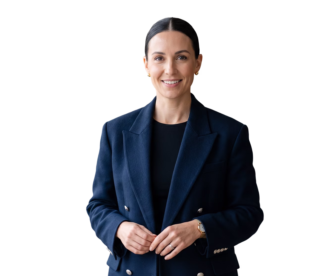 Smiling woman with dark hair in a navy blazer and black top, standing with hands clasped.