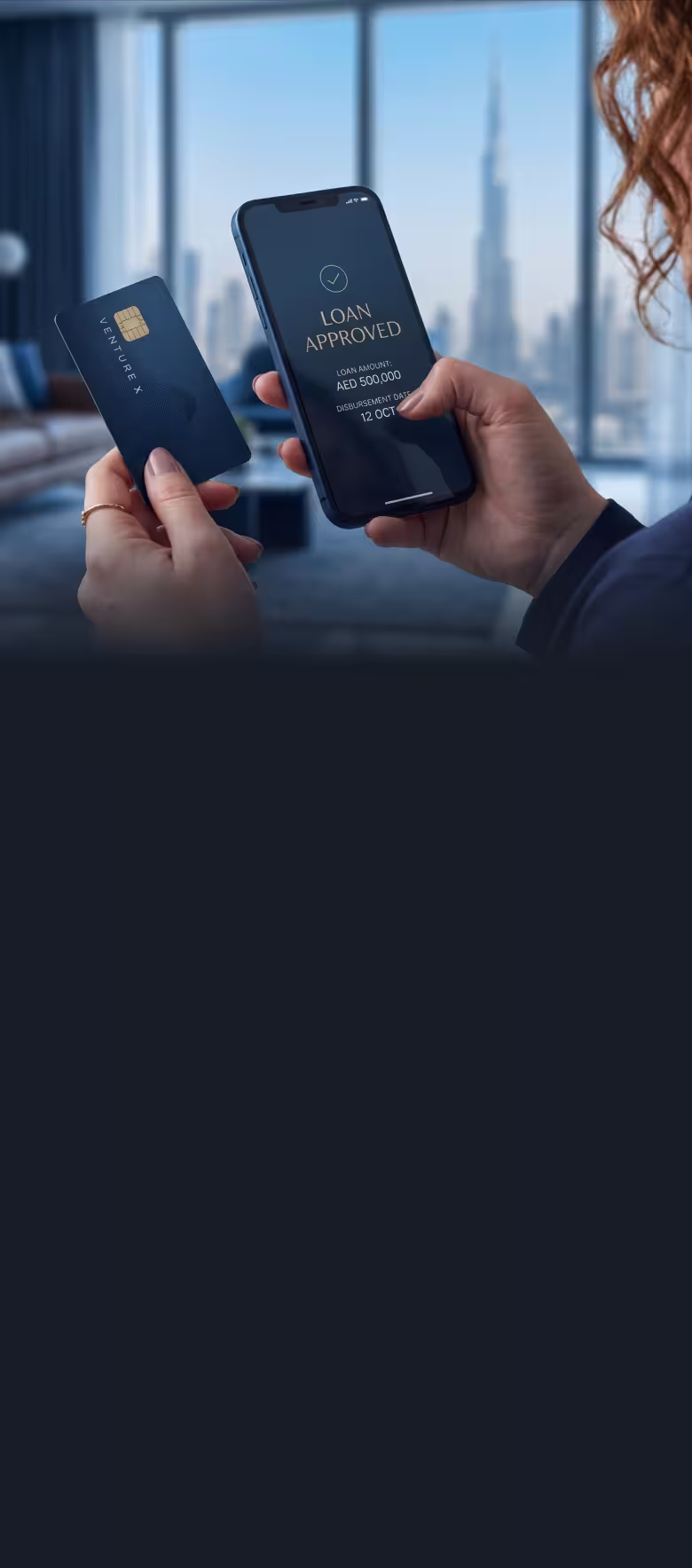 Person holding a credit card and phone displaying a loan approved message
