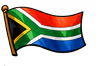 South African flag waving on a flagpole against a black background.