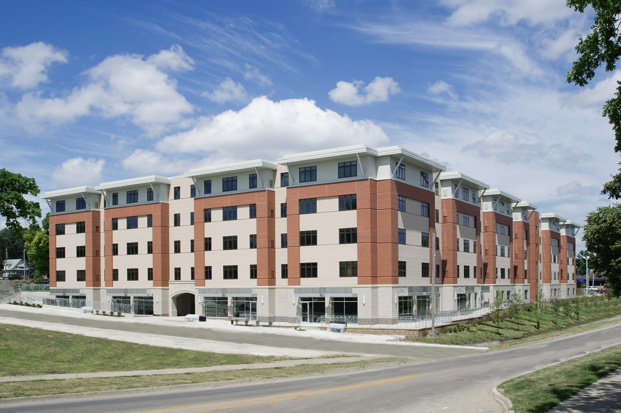 Exterior of Drake West Village from street during the day against blue sky