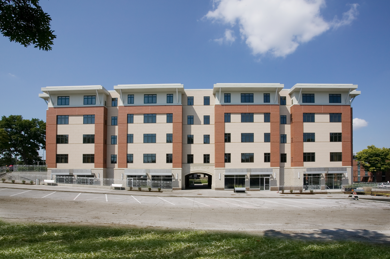 Exterior of Drake West Village from street during the day against blue sky
