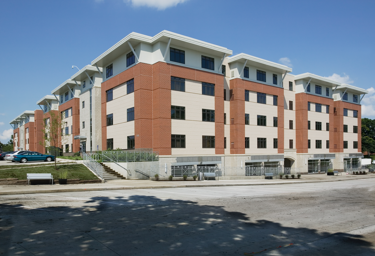 Exterior of Drake West Village from street during the day against blue sky