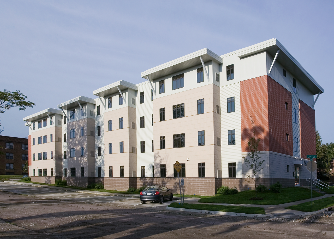 Exterior of Drake West Village from street during the day against blue sky