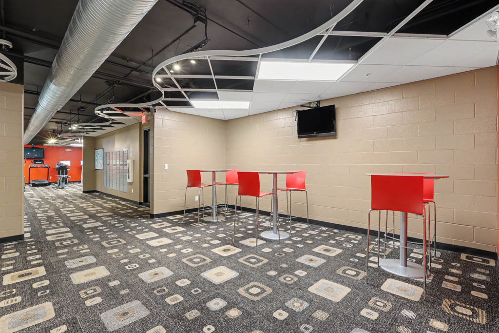 Laundry Facility with sitting area and view of gym