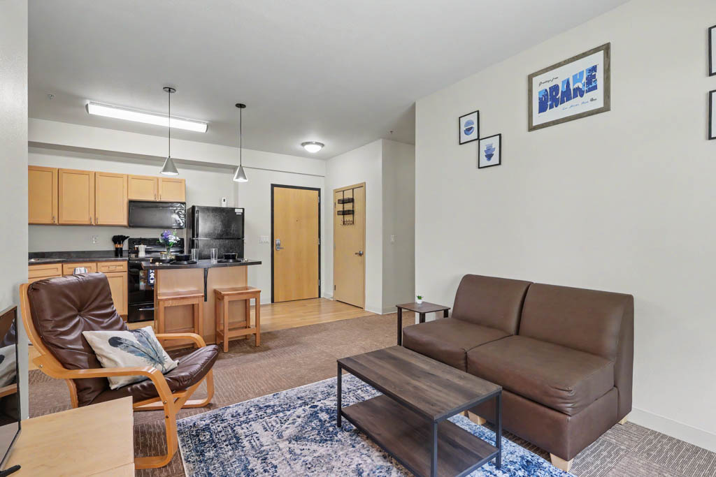 Living area with sofa and view of kitchen