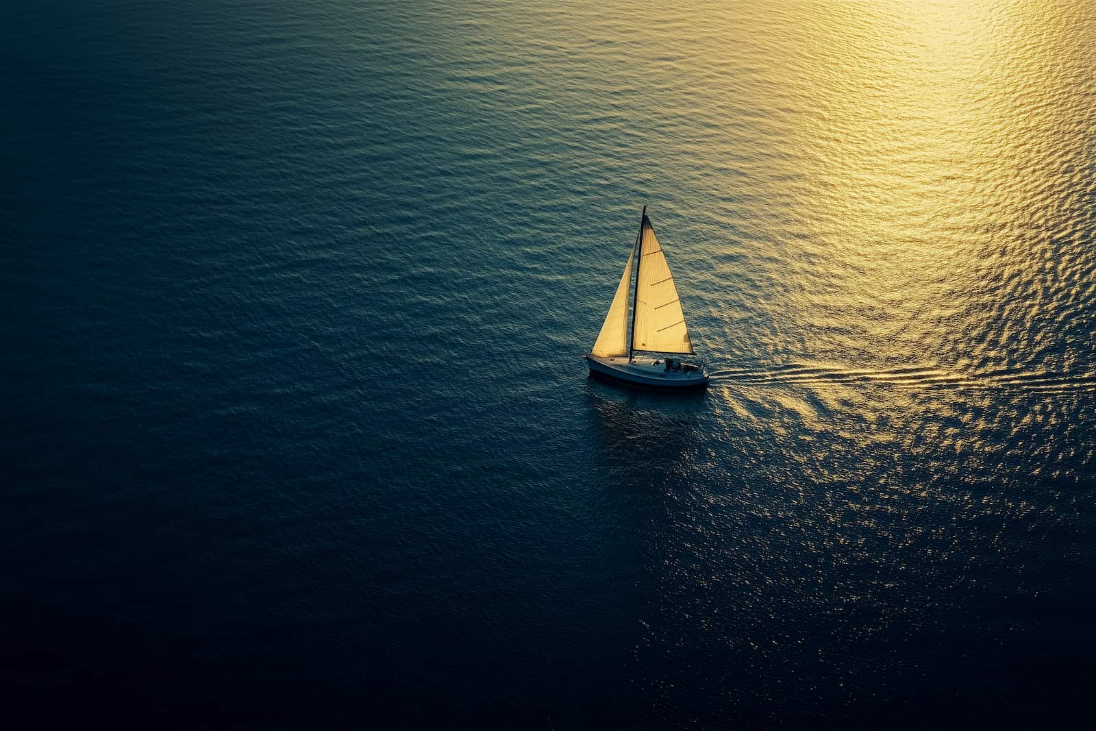 Lone sailboat on open water at sunset, representing the disorienting first stretch after a divorce settlement lands and the financial decisions that follow.