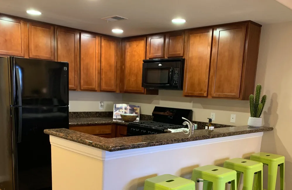 Kitchen with brown cabinets and black appliances