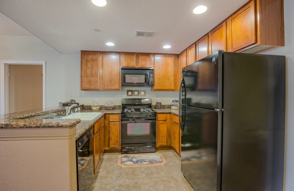 Kitchen with brown cabinets and black appliances