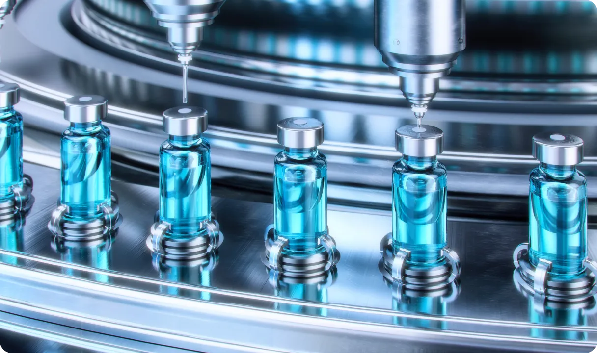Automated production line filling small glass vials with blue liquid in sterile environment.