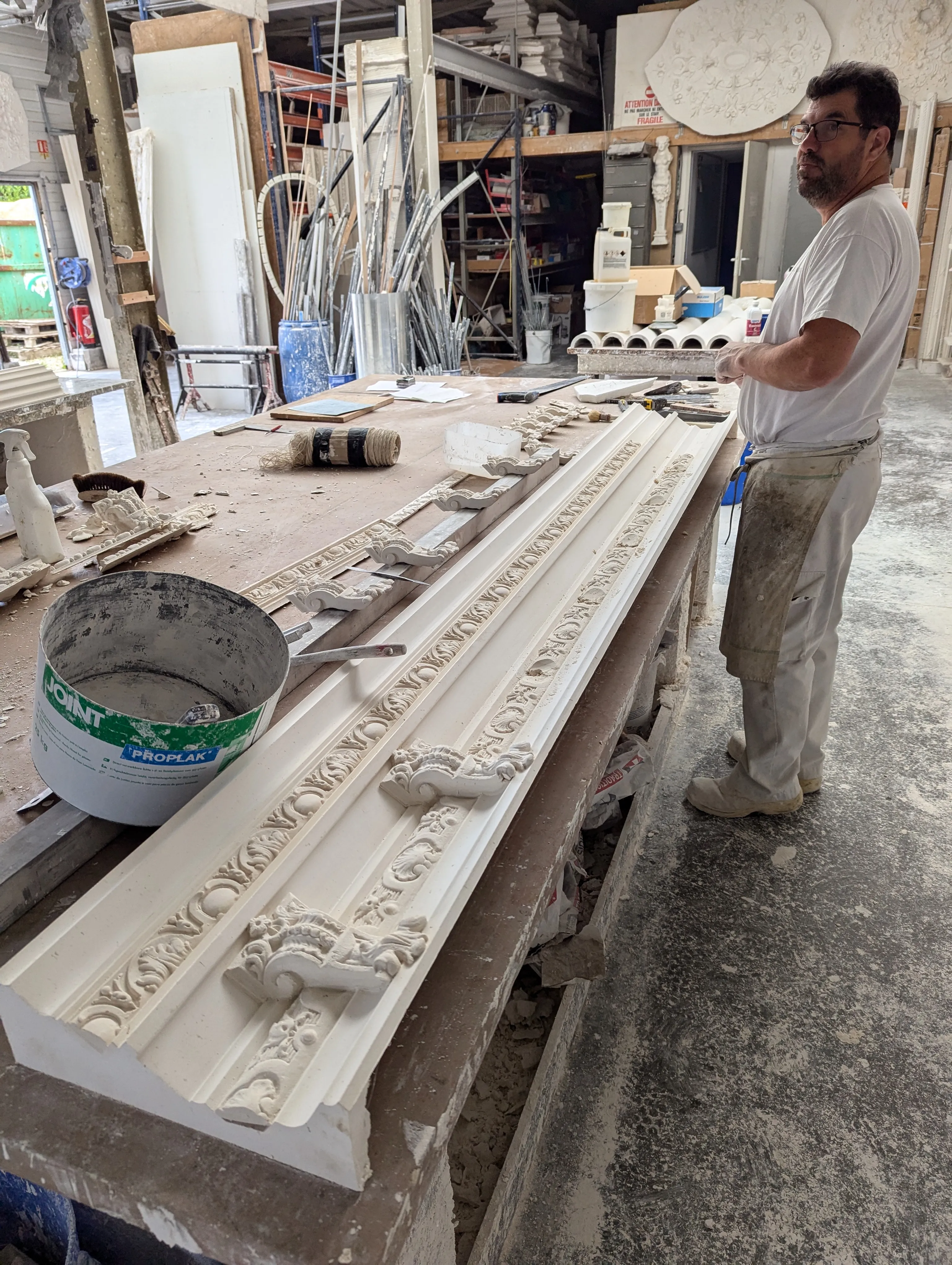 Assemblage d'une corniche ornée en staff en atelier
