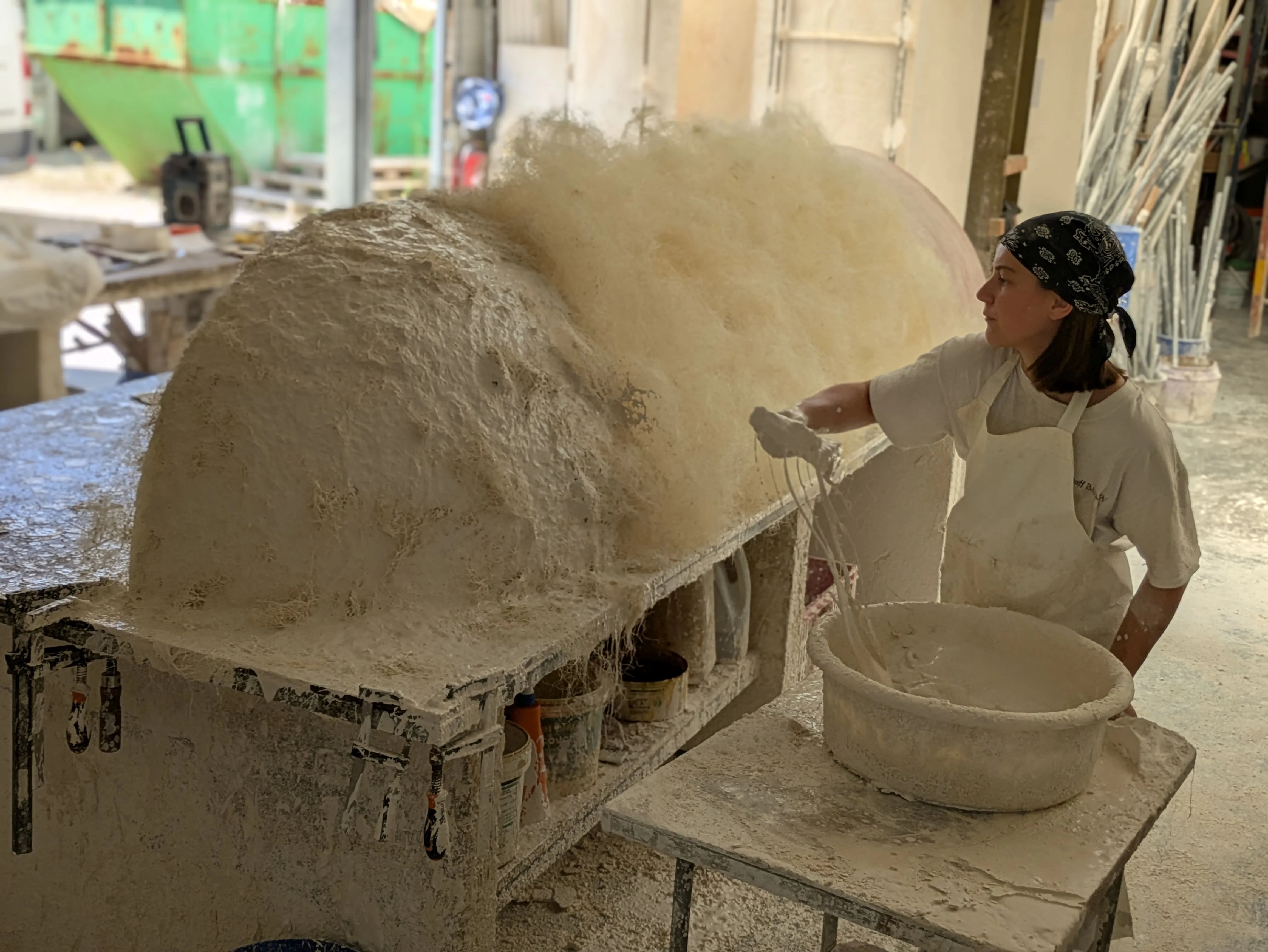Artisane travaillant le staff, mélange de plâtre et de filasse, à l'atelier