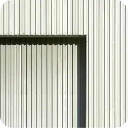 Light gray vertical metal panels with a rectangular shadow creating a geometric pattern.