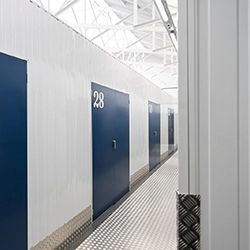 Light gray vertical metal panels with a rectangular shadow creating a geometric pattern.