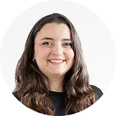 Smiling woman with long dark hair, white background.