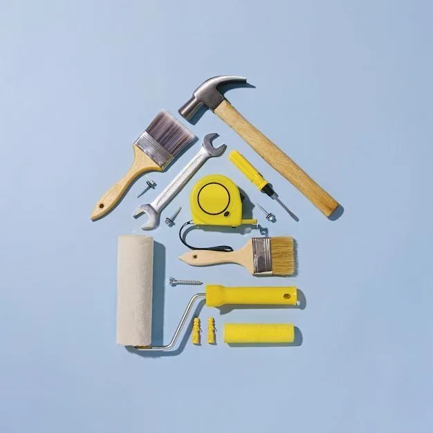 Outils de bricolage disposés en forme de maison sur fond bleu